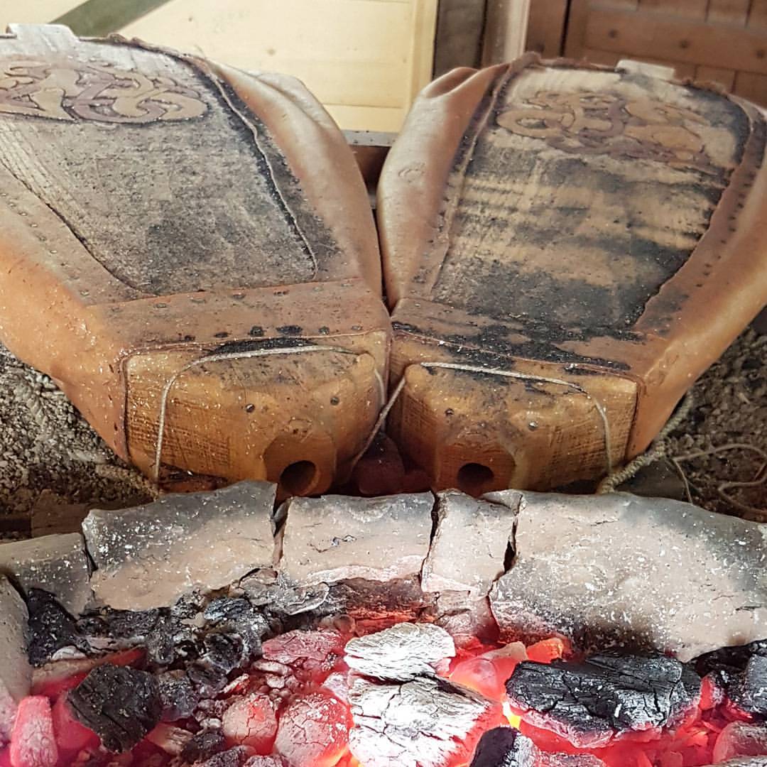 Resting bellows in the forge. A torn blaster stone between the fire and the bellows.